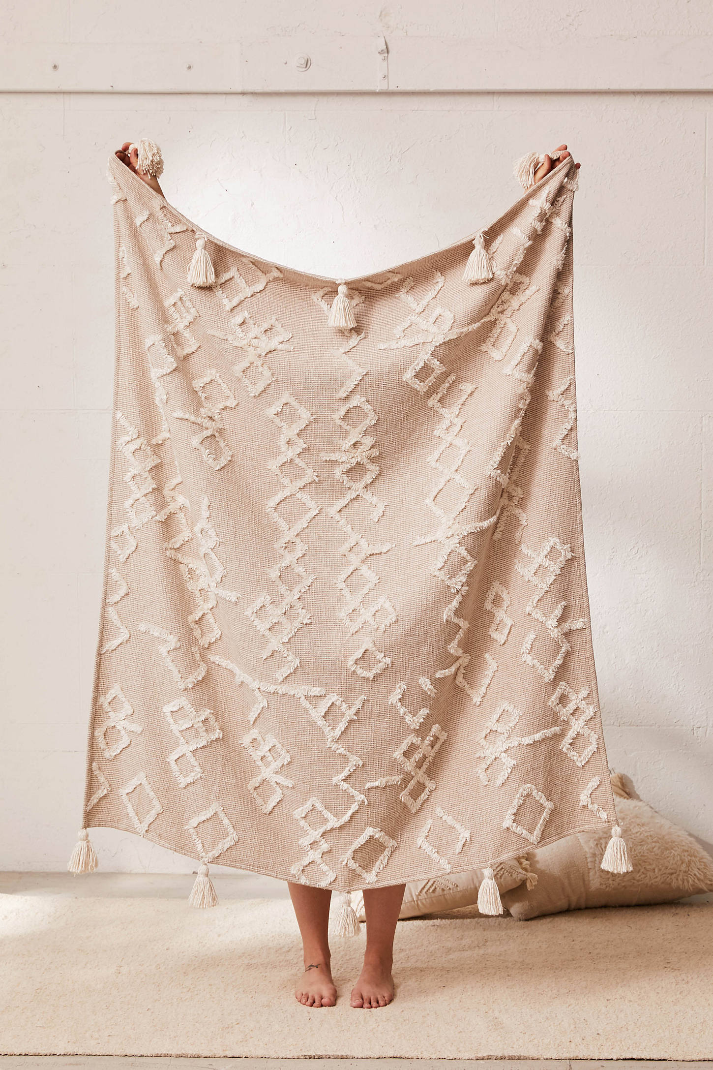 Shop Geo Tufted Tassel Throw Blanket from Urban Outfitters on Openhaus