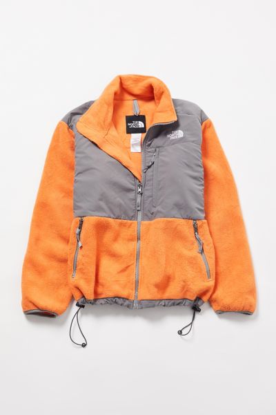 orange and grey north face jacket