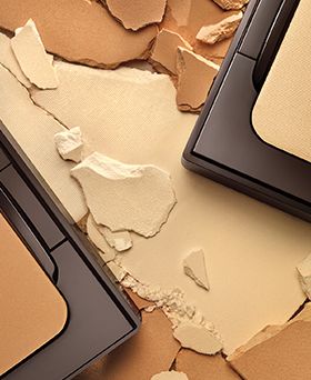 close up of crushed powder foundation and compacts